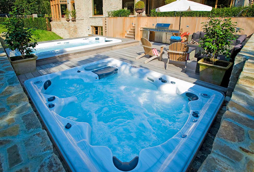 Hot tub and swim spa installed in an outdoor deck