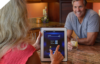 Woman remotely adjusting the hot tub temperature using an app on her tablet